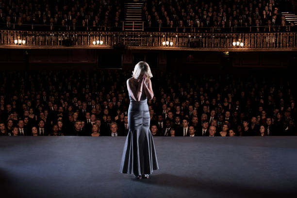 A girl having stage fright while on stage before a crowd